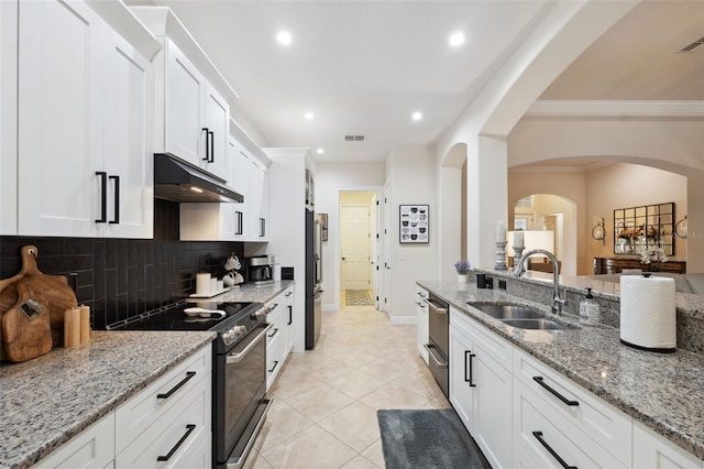 9426 Burnam Dr, Weeki Wachee, FL 34613 - kitchen featuring under cabinet range hood, a sink, stainless steel appliances, backsplash, and crown molding