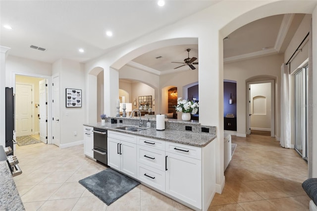 9426 Burnam Dr, Weeki Wachee, FL 34613 - kitchen featuring a sink, a ceiling fan, light stone counters, ornamental molding, and dishwasher