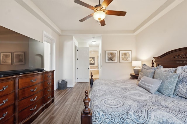 9426 Burnam Dr, Weeki Wachee, FL 34613 - bedroom featuring wood finished floors, baseboards, ensuite bathroom, and ceiling fan