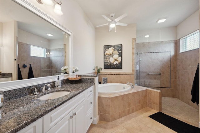 9426 Burnam Dr, Weeki Wachee, FL 34613 - full bathroom featuring vanity, tile patterned flooring, a bath, walk in shower, and a ceiling fan