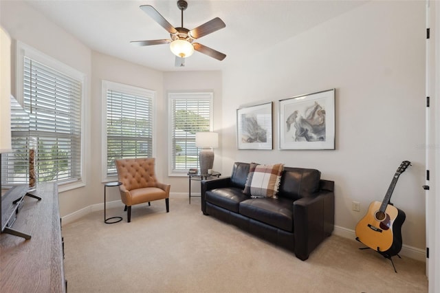 9426 Burnam Dr, Weeki Wachee, FL 34613 - living area with carpet flooring, a ceiling fan, and baseboards