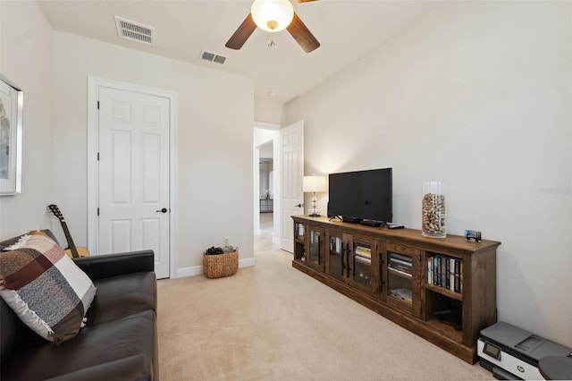 9426 Burnam Dr, Weeki Wachee, FL 34613 - carpeted living area with ceiling fan and baseboards