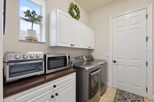 9426 Burnam Dr, Weeki Wachee, FL 34613 - washroom with washer and dryer, cabinet space, and light tile patterned floors