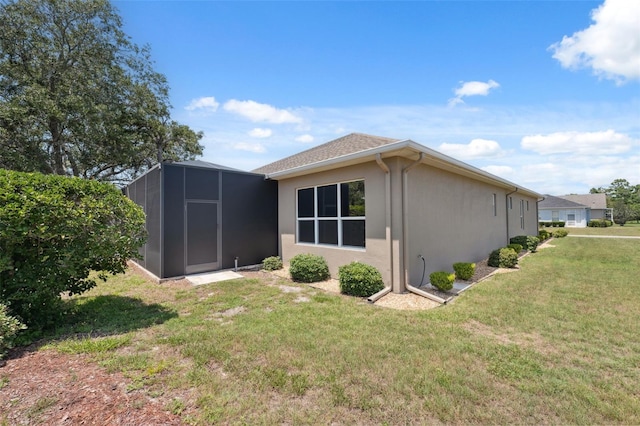 9426 Burnam Dr, Weeki Wachee, FL 34613 - rear view of property with a lawn, stucco siding, and a lanai