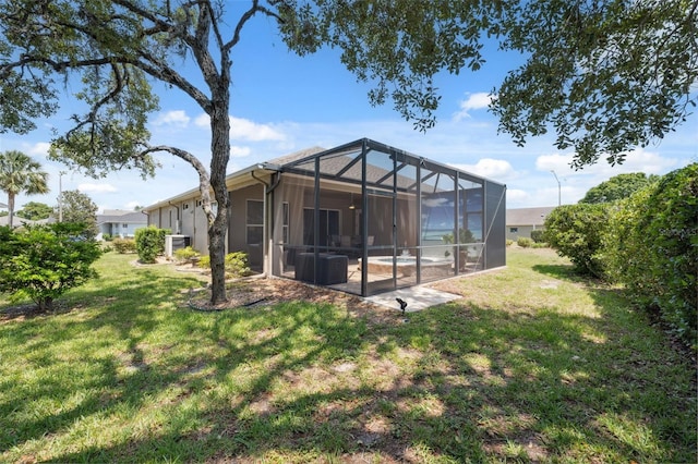 9426 Burnam Dr, Weeki Wachee, FL 34613 - back of house with a yard and glass enclosure