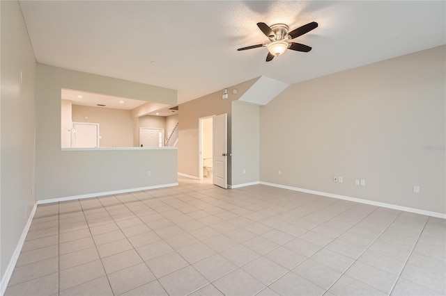 26622 Castleview Way, Wesley Chapel, FL 33544 - unfurnished living room with ceiling fan, baseboards, stairs, and light tile patterned floors