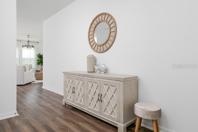 2363 Lancashire St, Davenport, FL 33896 - hallway featuring baseboards, a chandelier, and dark wood-style floors