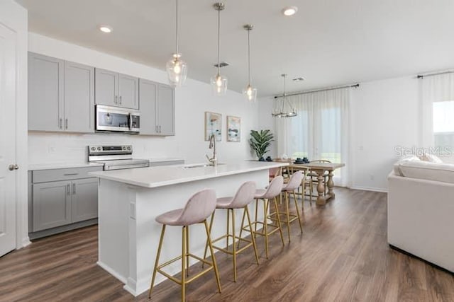 2363 Lancashire St, Davenport, FL 33896 - kitchen with appliances with stainless steel finishes, gray cabinets, a sink, dark wood-style flooring, and recessed lighting