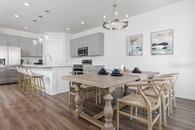 2363 Lancashire St, Davenport, FL 33896 - dining space featuring dark wood finished floors, recessed lighting, a chandelier, and baseboards