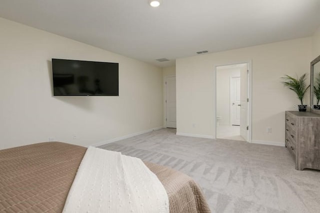 2363 Lancashire St, Davenport, FL 33896 - unfurnished bedroom with light colored carpet, baseboards, vaulted ceiling, and ensuite bathroom