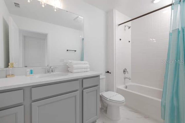 2363 Lancashire St, Davenport, FL 33896 - full bath featuring vanity, toilet, shower / bath combo with shower curtain, and marble look tile flooring