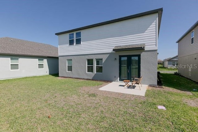 2363 Lancashire St, Davenport, FL 33896 - back of house featuring stucco siding, a lawn, a patio, and french doors
