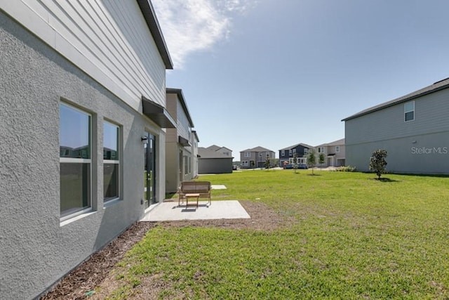 2363 Lancashire St, Davenport, FL 33896 - view of green lawn featuring a patio area and a residential view