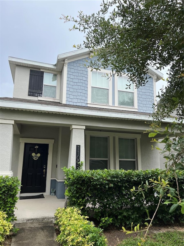 11097 N Folklore St, Winter Garden, FL 34787 - view of front of house with stucco siding and a porch
