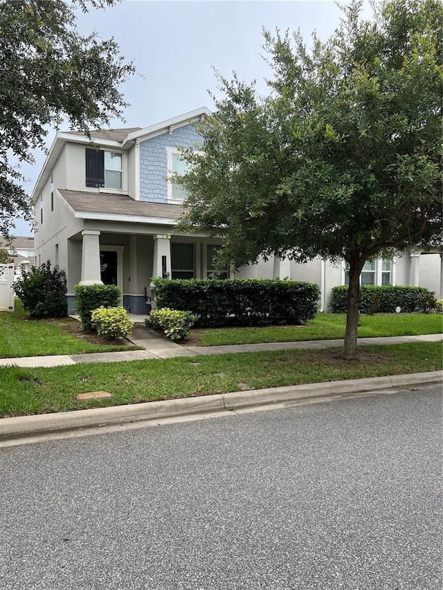 11097 N Folklore St, Winter Garden, FL 34787 - view of front facade with stucco siding and a front lawn