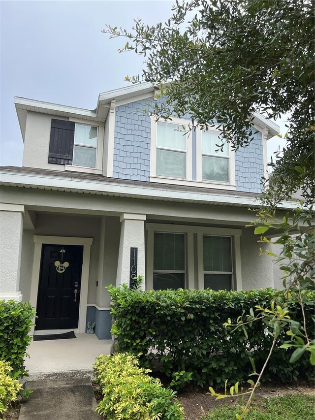 11097 N Folklore St, Winter Garden, FL 34787 - view of front of house with stucco siding and a porch