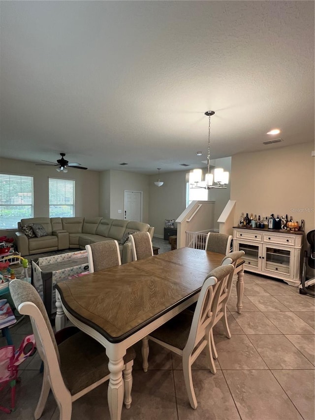 11097 N Folklore St, Winter Garden, FL 34787 - dining room featuring a chandelier, light tile patterned floors, ceiling fan, and a textured ceiling