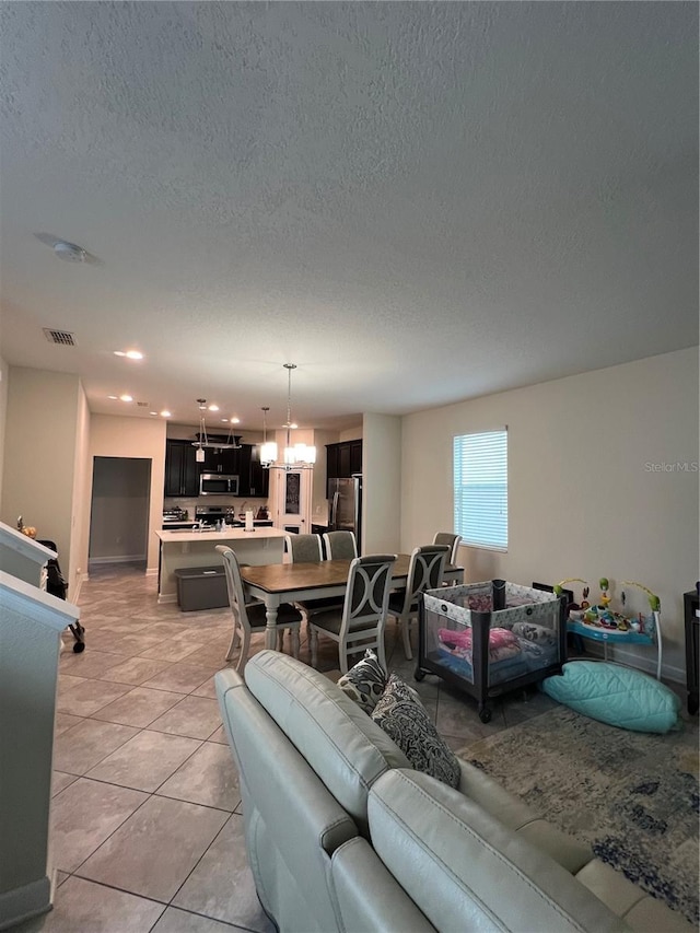 11097 N Folklore St, Winter Garden, FL 34787 - living room with a textured ceiling, light tile patterned flooring, a chandelier, recessed lighting, and baseboards