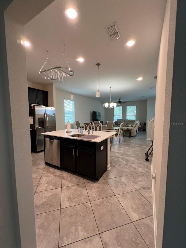 11097 N Folklore St, Winter Garden, FL 34787 - kitchen with stainless steel appliances, open floor plan, an island with sink, recessed lighting, and dark cabinetry