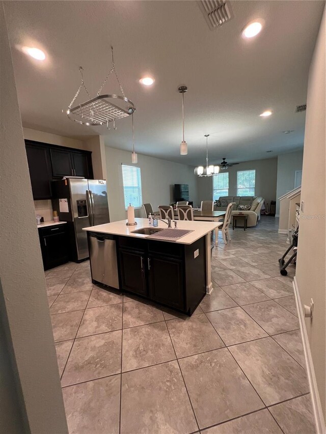 11097 N Folklore St, Winter Garden, FL 34787 - kitchen with a sink, appliances with stainless steel finishes, open floor plan, dark cabinetry, and recessed lighting