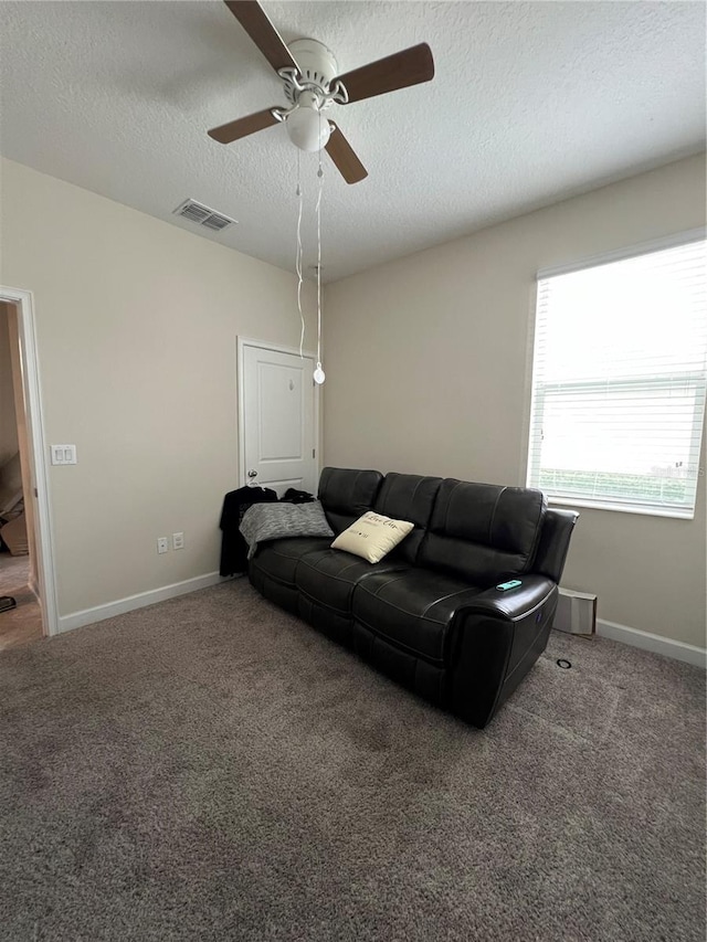 11097 N Folklore St, Winter Garden, FL 34787 - carpeted living room featuring ceiling fan, a textured ceiling, and baseboards