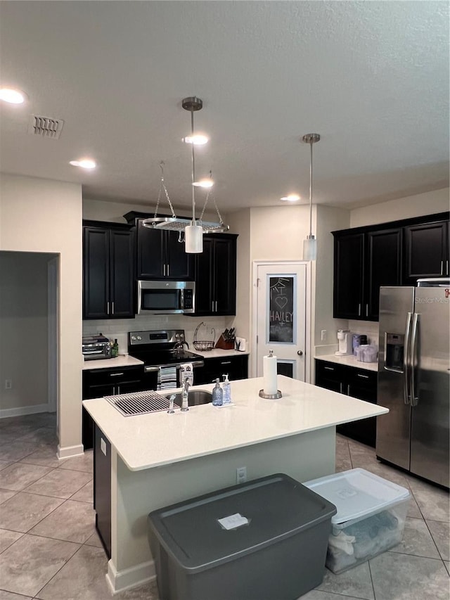 11097 N Folklore St, Winter Garden, FL 34787 - kitchen featuring stainless steel appliances, dark cabinetry, light tile patterned flooring, light countertops, and recessed lighting