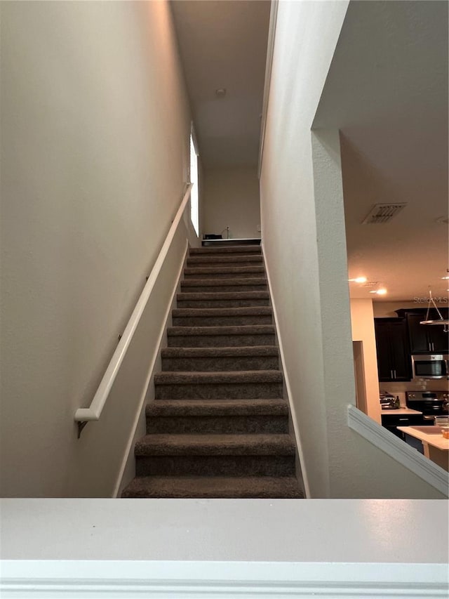 11097 N Folklore St, Winter Garden, FL 34787 - staircase featuring baseboards and carpet