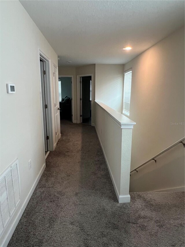 11097 N Folklore St, Winter Garden, FL 34787 - corridor with carpet, baseboards, and an upstairs landing