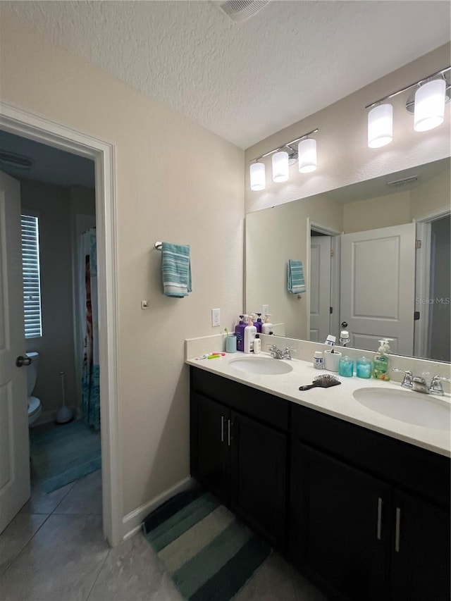 11097 N Folklore St, Winter Garden, FL 34787 - full bath with double vanity, toilet, tile patterned floors, and a textured ceiling