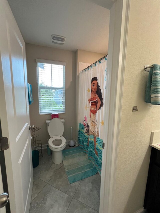 11097 N Folklore St, Winter Garden, FL 34787 - bathroom featuring toilet, tile patterned flooring, vanity, a shower with shower curtain, and baseboards