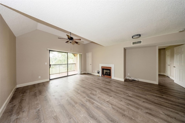 420 Forestway Cir Unit 306, Altamonte Springs, FL 32701 - unfurnished living room with a textured ceiling, ceiling fan, wood finished floors, a fireplace, and baseboards