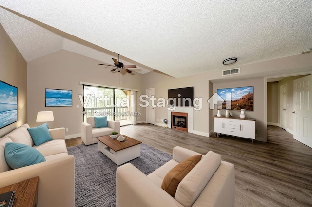 420 Forestway Cir Unit 306, Altamonte Springs, FL 32701 - living area featuring a textured ceiling, wood finished floors, ceiling fan, a fireplace, and baseboards