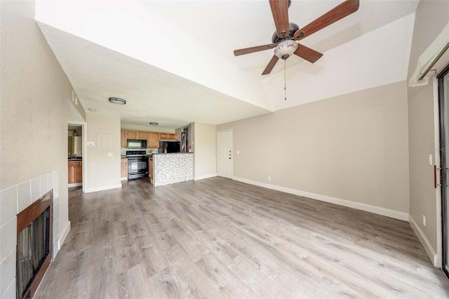 420 Forestway Cir Unit 306, Altamonte Springs, FL 32701 - unfurnished living room featuring a ceiling fan, a fireplace, wood finished floors, baseboards, and lofted ceiling