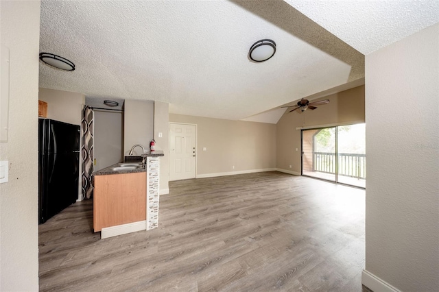 420 Forestway Cir Unit 306, Altamonte Springs, FL 32701 - kitchen with freestanding refrigerator, ceiling fan, a sink, light wood-type flooring, and a textured ceiling