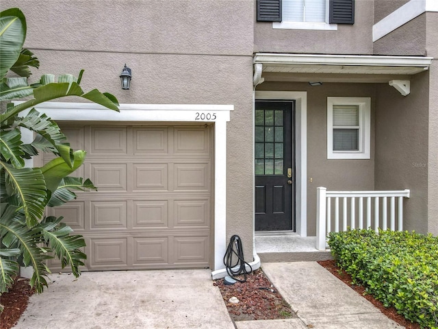 2005 Compass Flower Way, Ocoee, FL 34761 - doorway to property with stucco siding and a garage