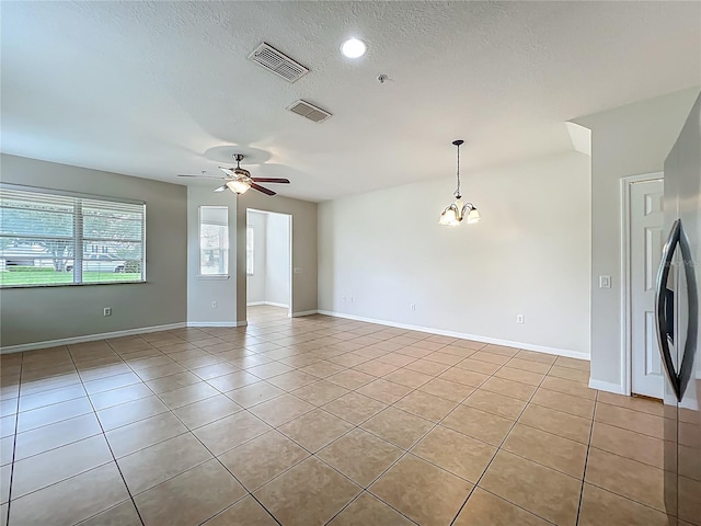 2005 Compass Flower Way, Ocoee, FL 34761 - unfurnished room featuring light tile patterned floors, a chandelier, a ceiling fan, baseboards, and a textured ceiling