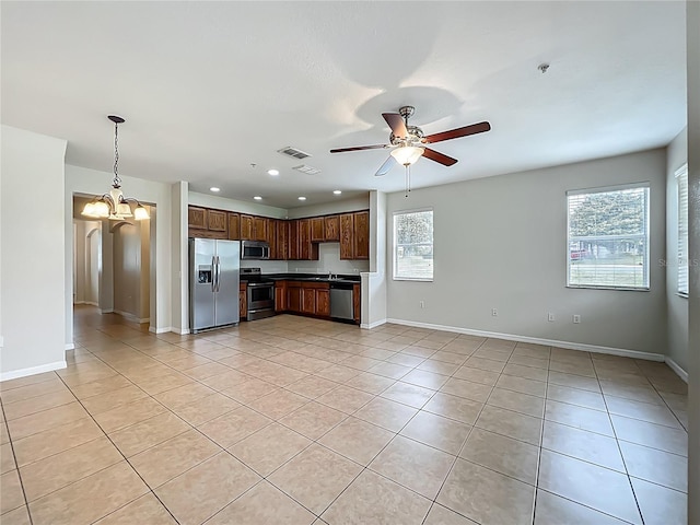 2005 Compass Flower Way, Ocoee, FL 34761 - kitchen with stainless steel appliances, light tile patterned floors, a chandelier, dark countertops, and ceiling fan