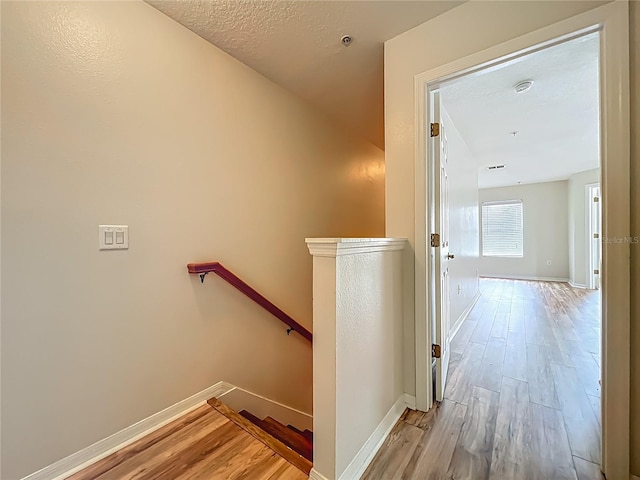 2005 Compass Flower Way, Ocoee, FL 34761 - hall with an upstairs landing, light wood-type flooring, and baseboards