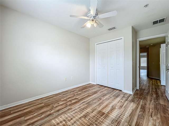 2005 Compass Flower Way, Ocoee, FL 34761 - unfurnished bedroom with wood finished floors, baseboards, a closet, and ceiling fan