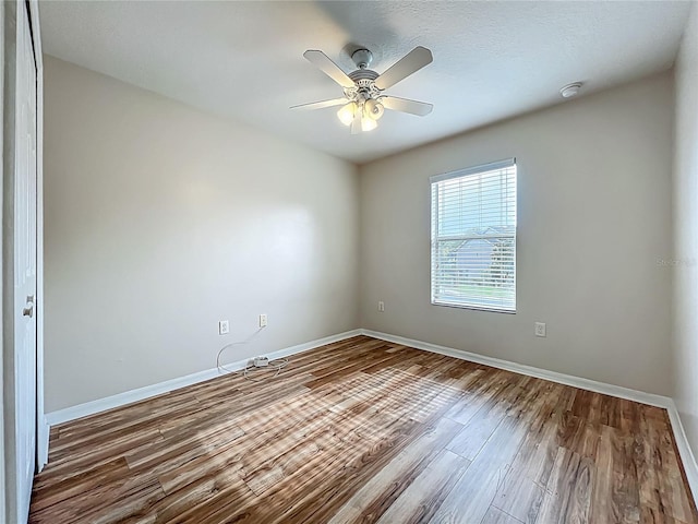 2005 Compass Flower Way, Ocoee, FL 34761 - empty room with wood finished floors, baseboards, a ceiling fan, and a smoke detector