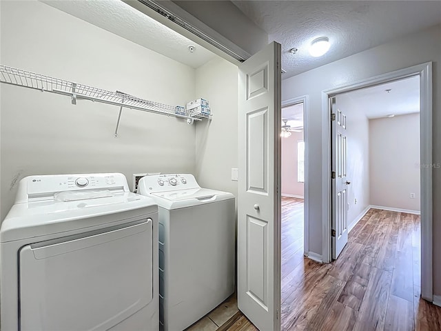 2005 Compass Flower Way, Ocoee, FL 34761 - laundry room featuring separate washer and dryer, wood finished floors, baseboards, ceiling fan, and a textured ceiling