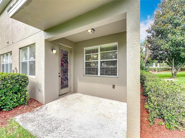 2005 Compass Flower Way, Ocoee, FL 34761 - property entrance featuring stucco siding and a patio area