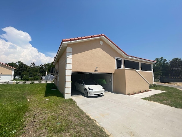 4865 S Tromp Loop, Homosassa, FL 34448 - view of home's exterior with a tile roof, a lawn, stucco siding, driveway, and a garage