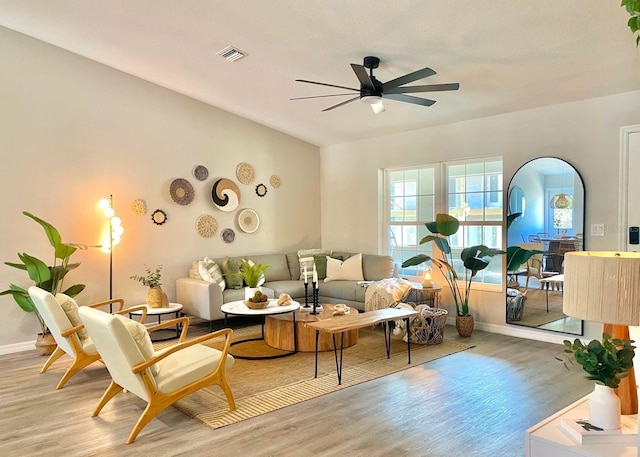 4865 S Tromp Loop, Homosassa, FL 34448 - living room featuring light wood-style flooring, a ceiling fan, baseboards, and arched walkways