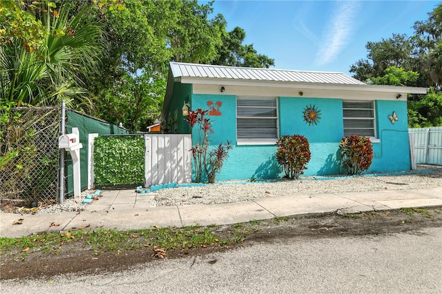 318 Palm St, New Smyrna Beach, FL 32168 - view of front of home with stucco siding and metal roof
