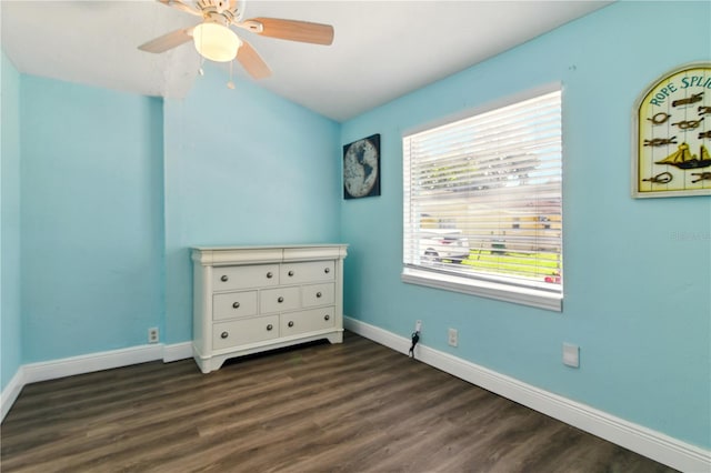 318 Palm St, New Smyrna Beach, FL 32168 - unfurnished bedroom with baseboards, dark wood-type flooring, and ceiling fan