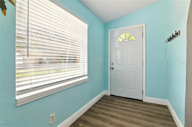 318 Palm St, New Smyrna Beach, FL 32168 - entrance foyer with baseboards, lofted ceiling, and dark wood finished floors
