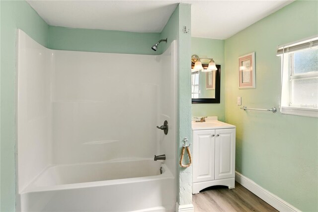 318 Palm St, New Smyrna Beach, FL 32168 - full bathroom featuring wood finished floors, vanity, shower / washtub combination, and baseboards
