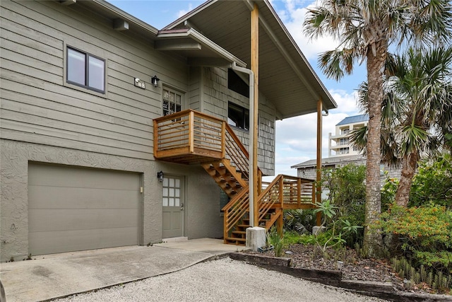 4365 S Atlantic Ave Unit B8, New Smyrna Beach, FL 32169 - view of building exterior featuring concrete driveway, stairs, and an attached garage