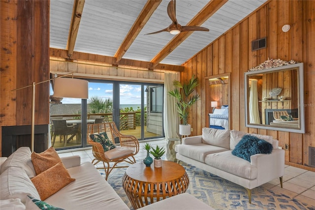 4365 S Atlantic Ave Unit B8, New Smyrna Beach, FL 32169 - living area featuring wooden walls, tile patterned flooring, ceiling fan, wood ceiling with exposed beams, and high vaulted ceiling